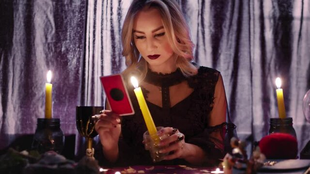 Fortune teller tarot reader looking at card and reading future and fortune