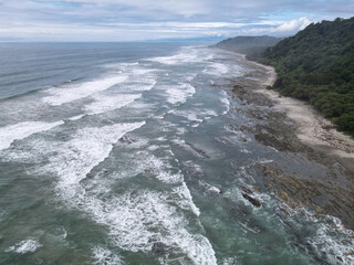	
Lush Tropical Beach Paradise with blue water, great waves and rock formations in Malpais / Santa Teresa, Nicoya Peninsula Costa Rica	
