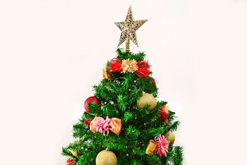 Christmas tree with beautiful decoration of spheres and topknots and a star on top.