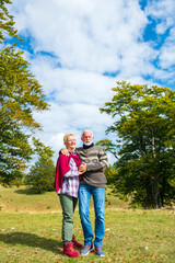 Fototapeta premium Senior couple on a walk in an autumn nature.