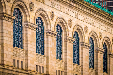 Fototapeta na wymiar The stone and large arching windows of the original Boston Public Library