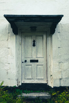 Beautiful Rural White Rustic Door With Overgrown By Weeds Stairs, British Countryside House In The Middle Of Nowhere.