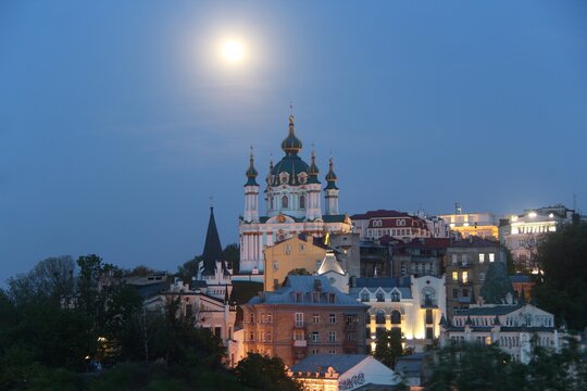 St. Andrew's Church was built in the Baroque style in 1749-1754 by the architect Rastrelli. It is located on Andreevskaya Hill above the historical part of Podol. Full Moon. Kiev city. © Andrii