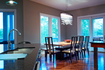 Interior modern kitchen and eating area with wood floor and stylish design