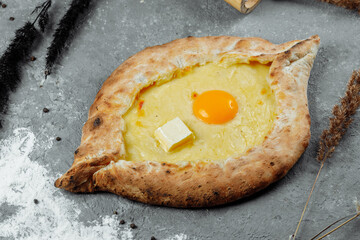Khachapuri in Adjarian. Open pie with mozzarella and egg. Georgian cuisine