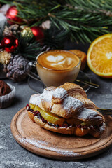 New Year's breakfast with croissants. New Year's croissant with chocolate and baked orange