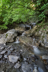 Naklejka na ściany i meble Wonderful clear water creek in french alps with rocks
