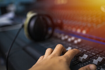 Music on sound mixer in recording studio.