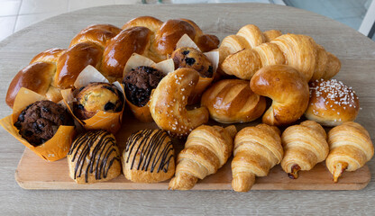 Assorted bakery products like croissants, muffins and a Brioche bread