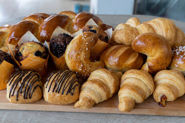 Assorted bakery products like croissants, muffins and a Brioche bread