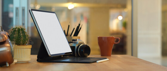 Female hands using smartphone on wooden worktable in home office
