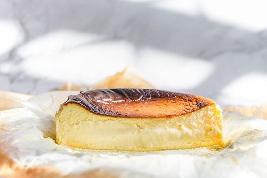 Homemade of basque burnt cheesecake on paking paper.