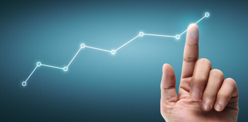 Hand touching a graphs of financial indicator accounting market economy analysis chart