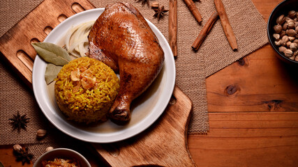 Tasty chicken biryani with rice marinated in spices on wooden table in restaurant