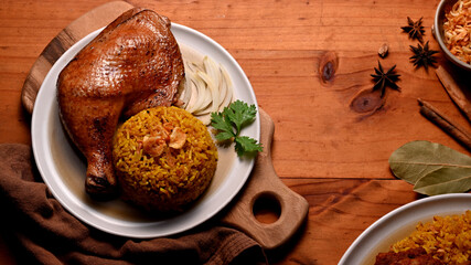 Delicious chicken biryani with rice marinated in spices on kitchen table