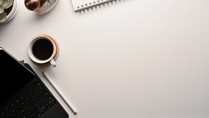 White table with copy space, tablet keyboard, stylus and stationery