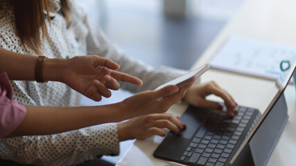 Businesspeople consulting on their project with tablet and smartphone