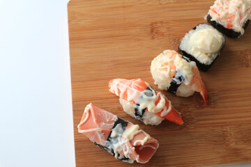 Overhead japanese sushi food on a wooden tray