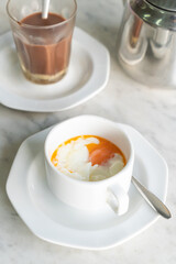 Soft-boiled eggs in white cup