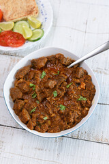 Spicy beef curry , Goan style beef vindaloo , Traditional Indian Lamb or beef curry . spicy Beef curry gravy popular in Kerala Sri Lankan Goa side dish for Appam, Parotta porotta roti bread in India.
