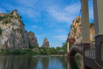 Khao Ngu Stone,Stone mountain with blue sky and lake in front.