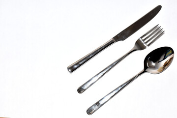 Cutlery Silverware Set with Spoons, forks, steak knives isolated on white background with copy space. Selective Focus.