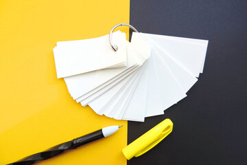 blank sheets of Notepad are held together with a metal ring , mockup, pen and black yellow...