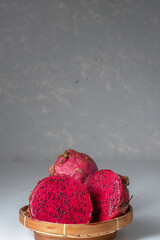 Red dragon fruit or pitahaya fruit in bamboo basket 
