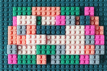 Small plastic building blocks on white background