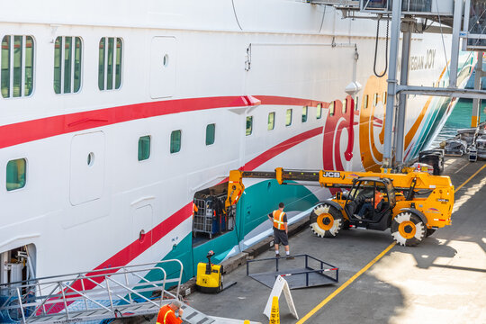 San Pedro, California - October 11 2019: Industrial Forklift Hydraulic Truck load/ unload luggage for Norwegian NCL Joy Ship docked at Port of Los Angeles World Cruise Center, LA Waterfront, San Pedro