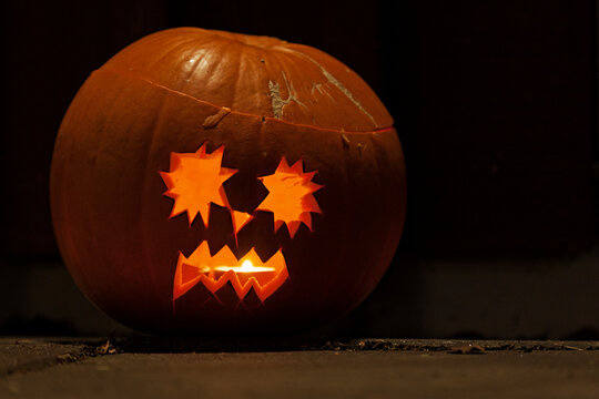 halloween pumpkin standing on the ground and looking scary