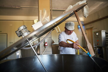 Cheese maker at local production factory