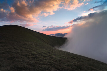 Panoramic view of the clouds high in the mountains on the mountain pass.