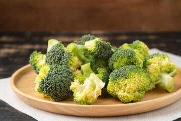sliced broccoli on wooden plate on the table