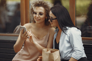 Women shopping. Two elegant woman in a city. Ladies in a stylish dress