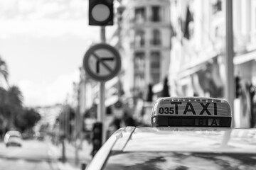Nice, France, October 8, 2019. Urban view. Taxi car on the background of Promenade des Anglais embankment. 