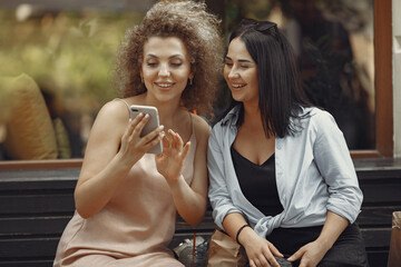 Women shopping. Two elegant woman in a city. Ladies in a stylish dress