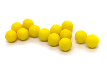 Round yellow pills isolated items on white background