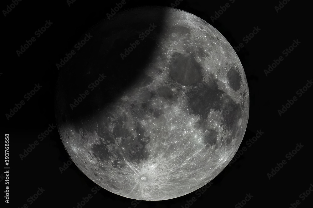 Wall mural a large photo of a lunar eclipse through a telescope. moon with high magnification. lunar surface wi
