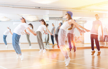 Fototapeta premium Focused teenage hip hop dancers doing dance workout during group class