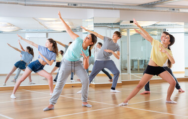 Fototapeta na wymiar Group of teenage boys and girls enjoying dance class together