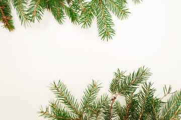 Christmas flat composition of fir branches with copy space for text. Top view on white background