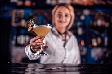Sweet woman barman makes a show creating a cocktail
