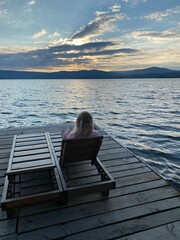 Fototapeta premium person sitting on a pier