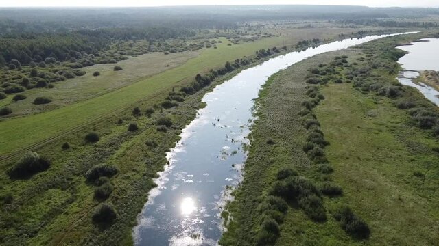 Top view of a wide full-flowing river with islands. Summer sunny day. Aerial photography