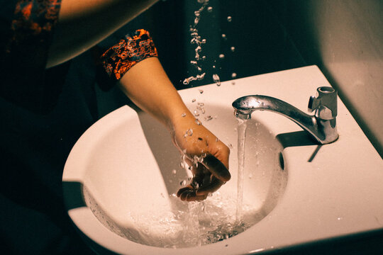Cropped Image Of Woman Washing Hands In Sink