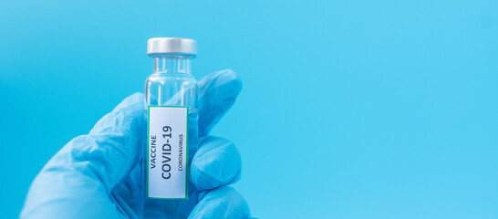 COVID-19 Vaccine vial against Coronavirus infection in hand of doctor with Nitrile Glove in hospital laboratory. Medical, health, Vaccination and immunization concept