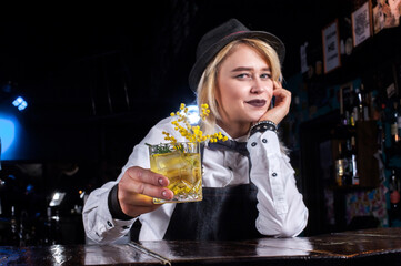 Girl bartender makes a cocktail on the brasserie