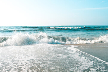 Fototapeta na wymiar Waves on the blue beach