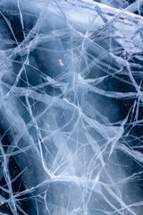 White cracks in thick ice. The natural texture of ice. Vertical.